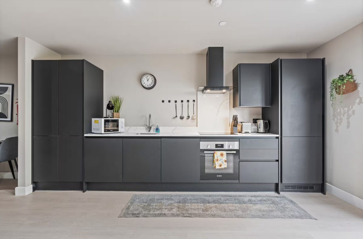 Kitchen with matte dark grey cabinets and white worktops